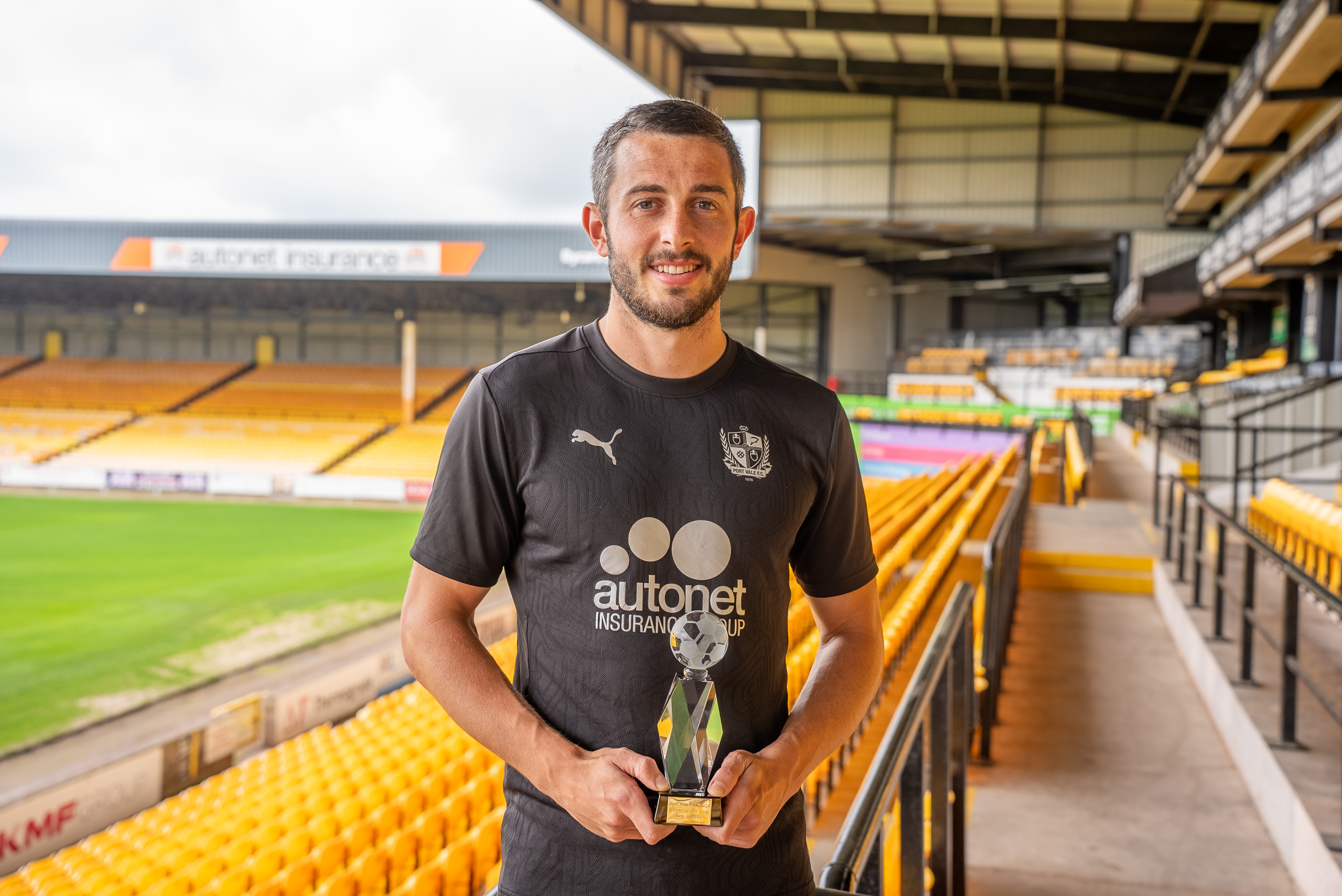 Ben Garrity holding the 2024/25 Player of the Year trophy