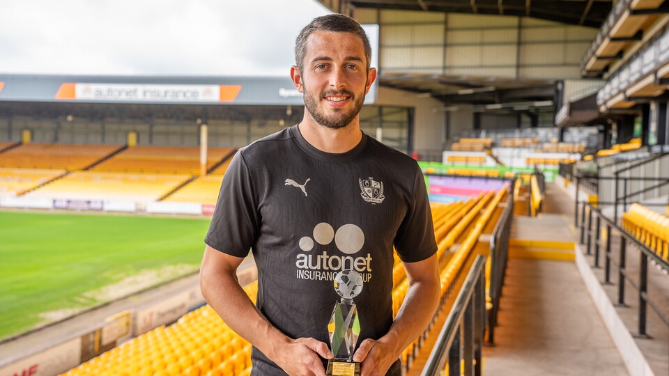 Ben Garrity holding the 2024/25 Player of the Year trophy